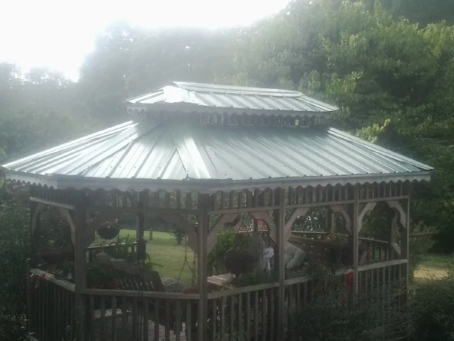 Two tier green metal roof on a garden gazebo in Montrose